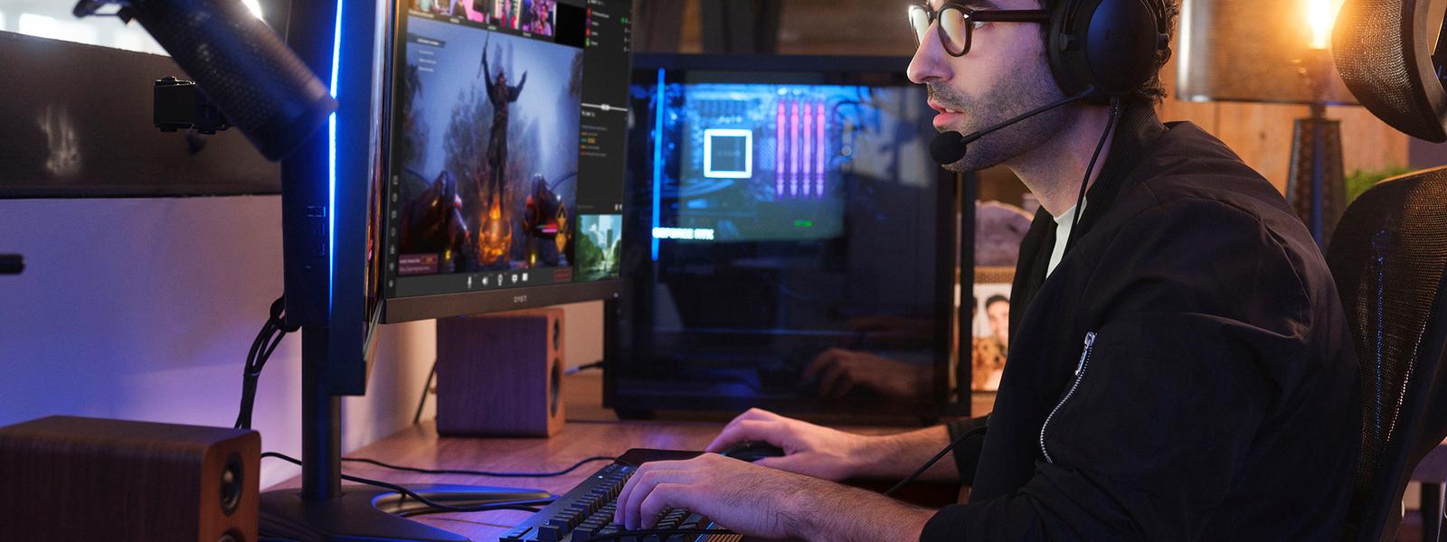 Man working at desk with multiple screens